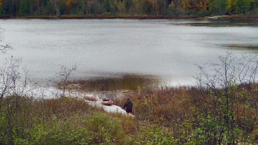 Man Preparing Canoe Lakeside in 4K